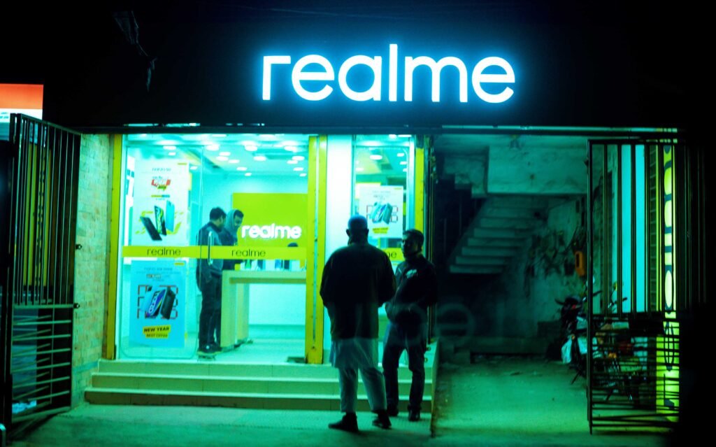 Night view of the realme smartphone store on Naogaon Sadar's main road.