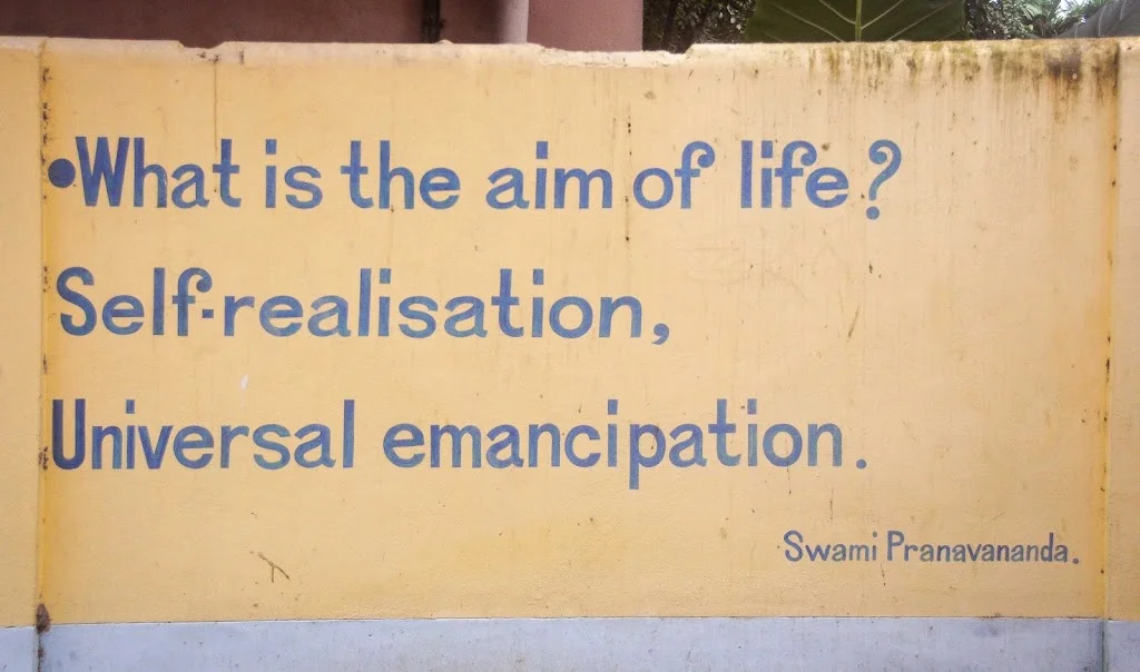 Swami Pranavananda's English quote on life's ups and downs at Naogaon Sevashram Sangha wall.
