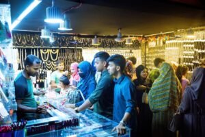 Visitors to the fair are shopping at a cosmetics shop.