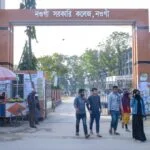 Boy and girl students are shown in front of Naogaon govt. college main gate