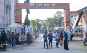 Boy and girl students are shown in front of Naogaon govt. college main gate