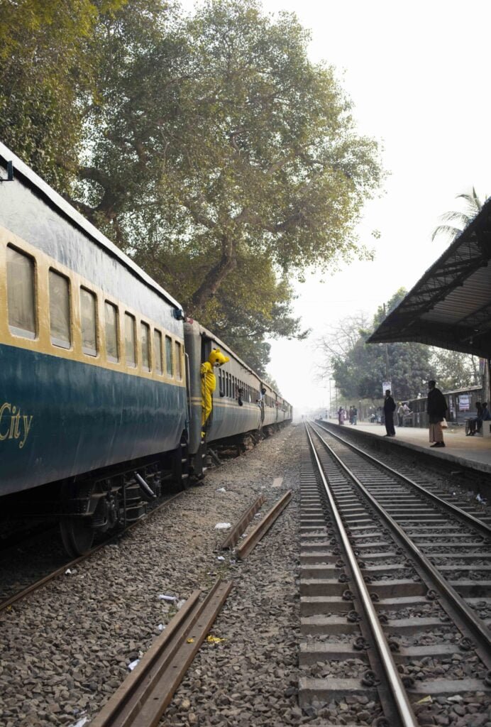 Passenger in yellow teddy bear costume at Raninagar train station