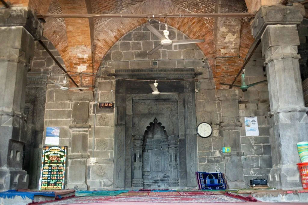 Interior of Kusumba Mosque showing two main pillars and central Mihrab - 2023.