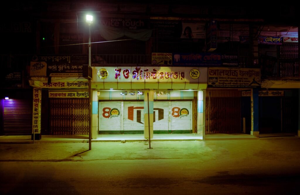 Nighttime glimpse of Naogaon Mishtanno Bhandar at Naogaon Bridge Mor.