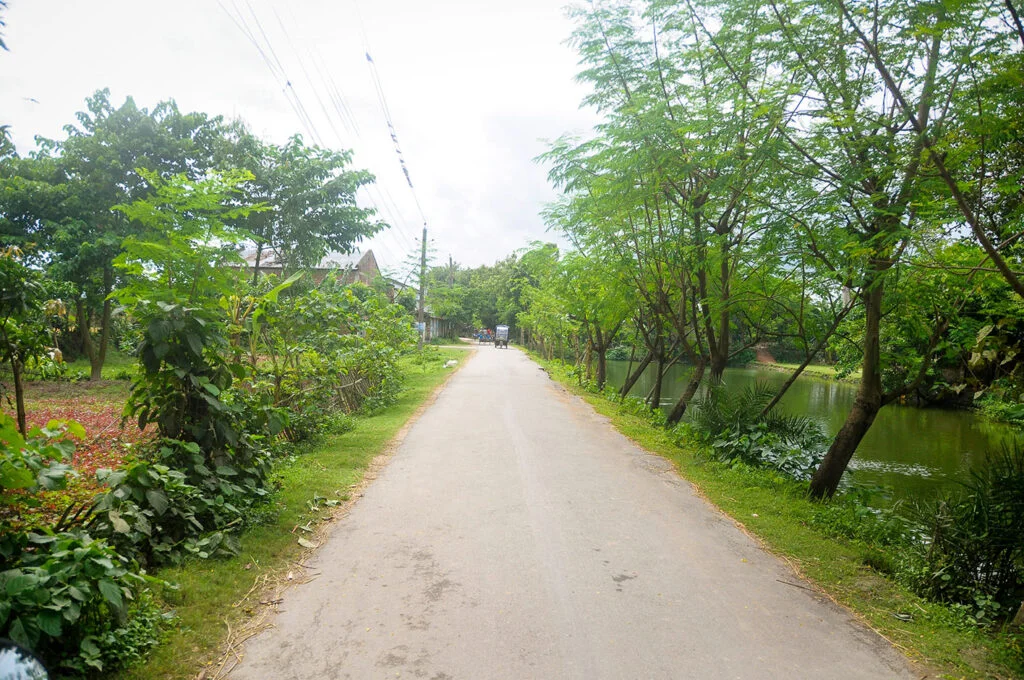 This beautiful road leads to Taltoli, passing through the serene Chalkpran Village of Naogaon, as photographed in 2014.