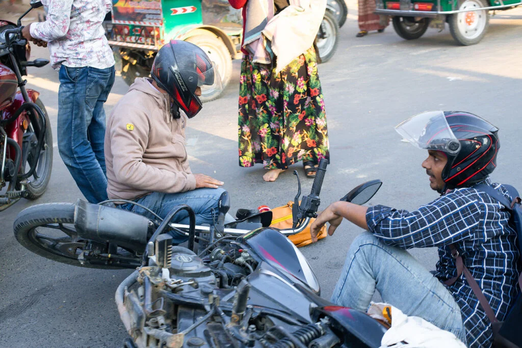 Bike accident scene on the main road close to Naogaon Judge Court. Photo by Rumon Anam in 2022.