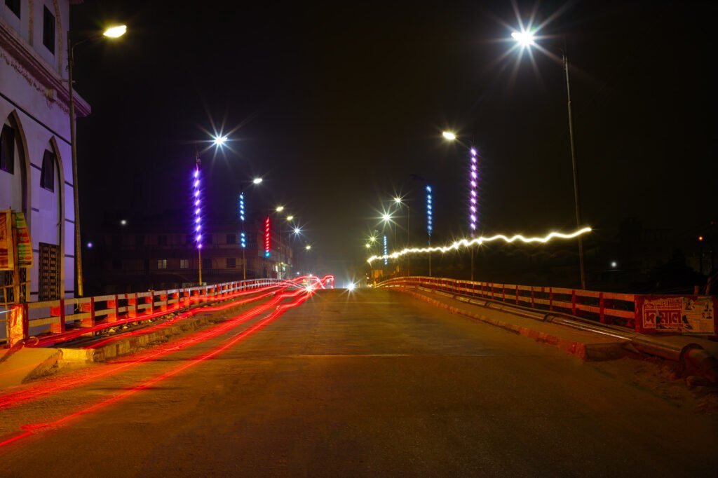 HD photo of light trails on Naogaon Lord Liton Bridge at night, captured in 2023 AD.