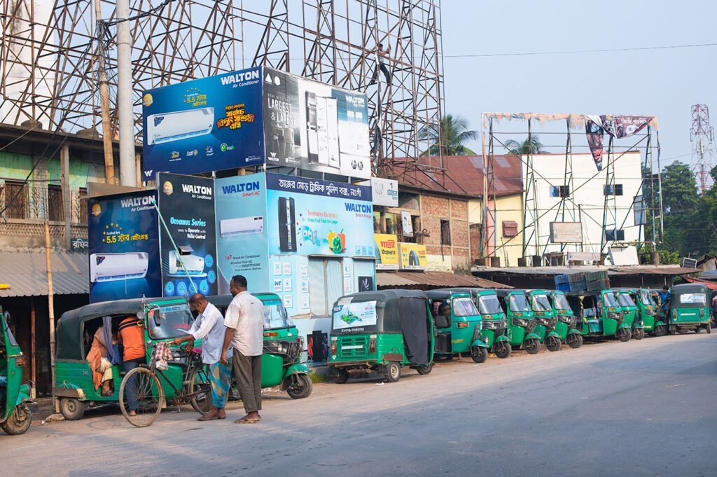 Sunny day view of Tajer Mor Traffic Box in Naogaon.