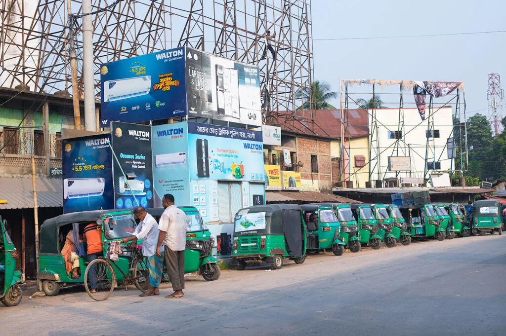 Sunny day view of Tajer Mor Traffic Box in Naogaon.