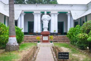 Full-body statue of middle-aged Rabindranath Tagore in historical Patisar Kachari bari, Atrai, sculpted by Kanak Kumar Pathak.