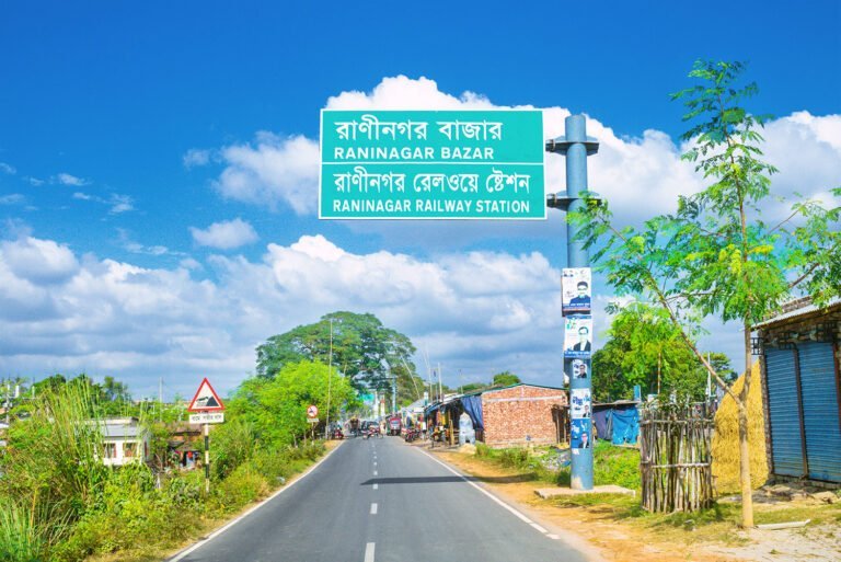 Bright HD day view from south of Raninagar Railway Station with road sign on Naogaon to Natore highway. Photo - 2023.