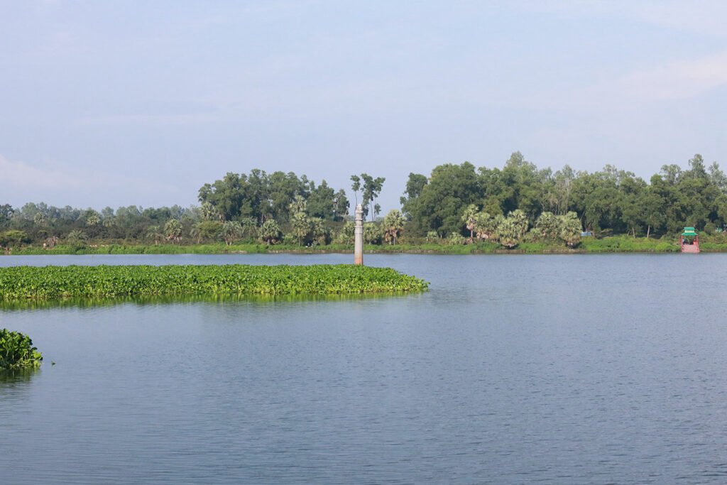Single-piece granite Dibyak Victory Pillar in the middle of historic Dibar Dighi, Naogaon.